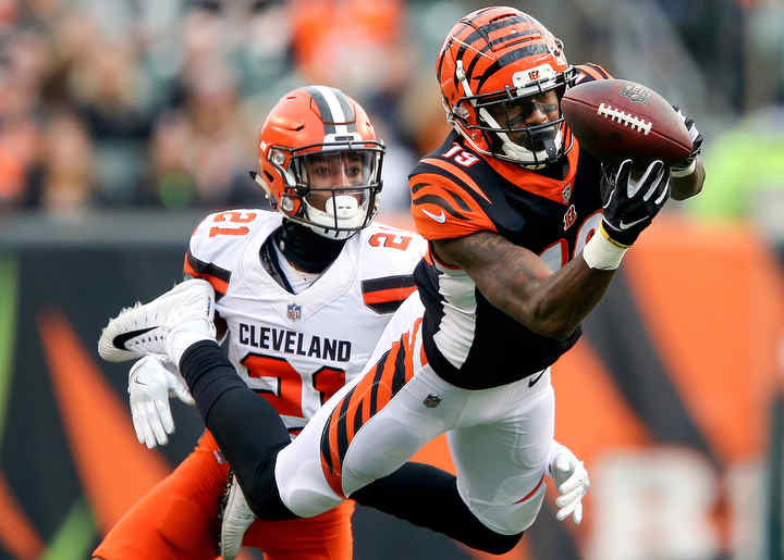 Cincinnati Bengals wide receiver Auden Tate (19) is unable to complete a catch as Cleveland Browns cornerback Denzel Ward (21) defends in the fourth quarter of a game at Paul Brown Stadium in Cincinnati.  (Kareem Elgazzar / The Cincinnati Enquirer)